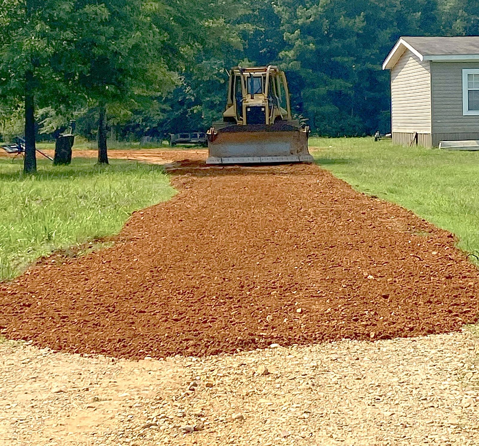 Fresh red gravel drive beside a home
