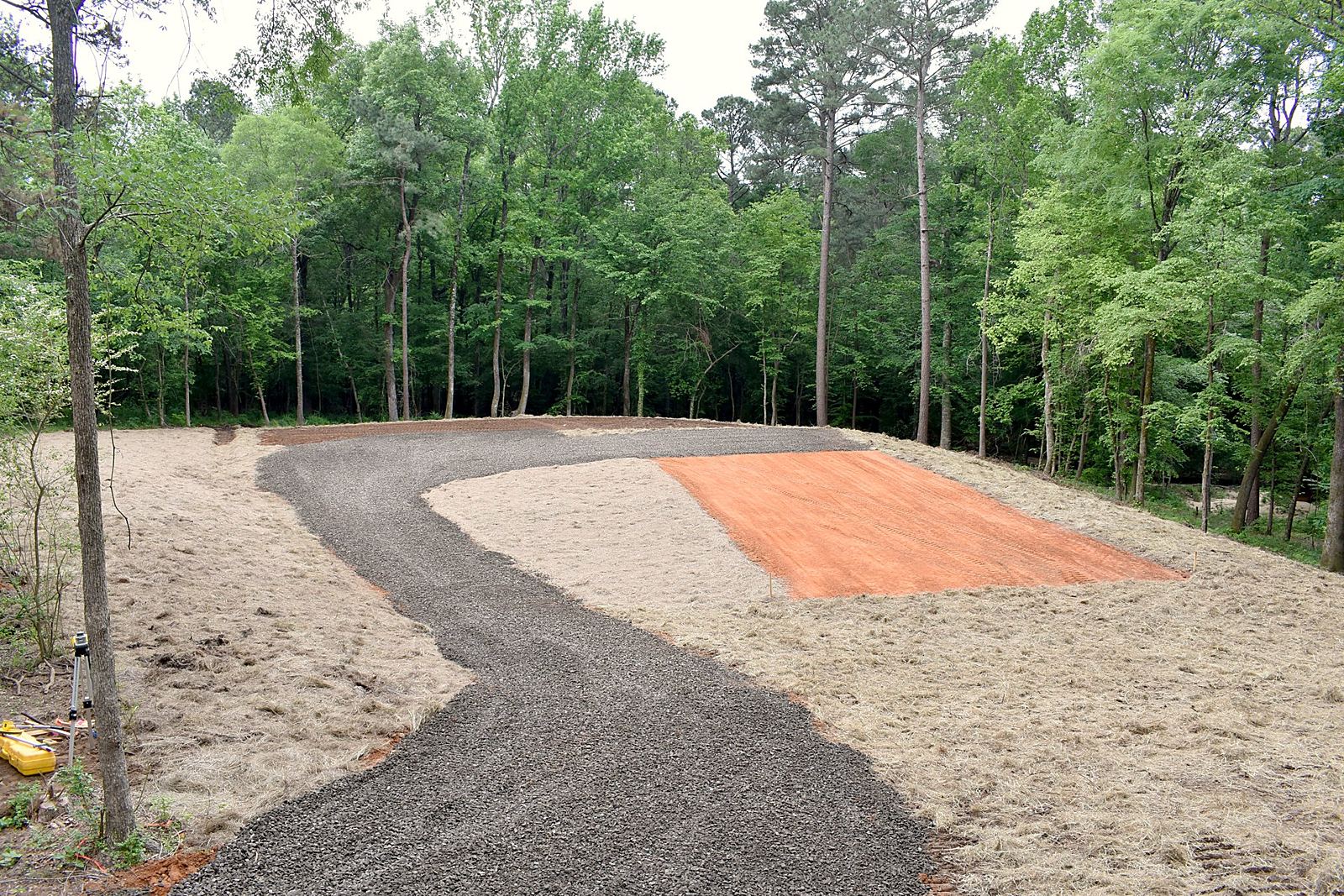 Winding gravel road and fresh pad